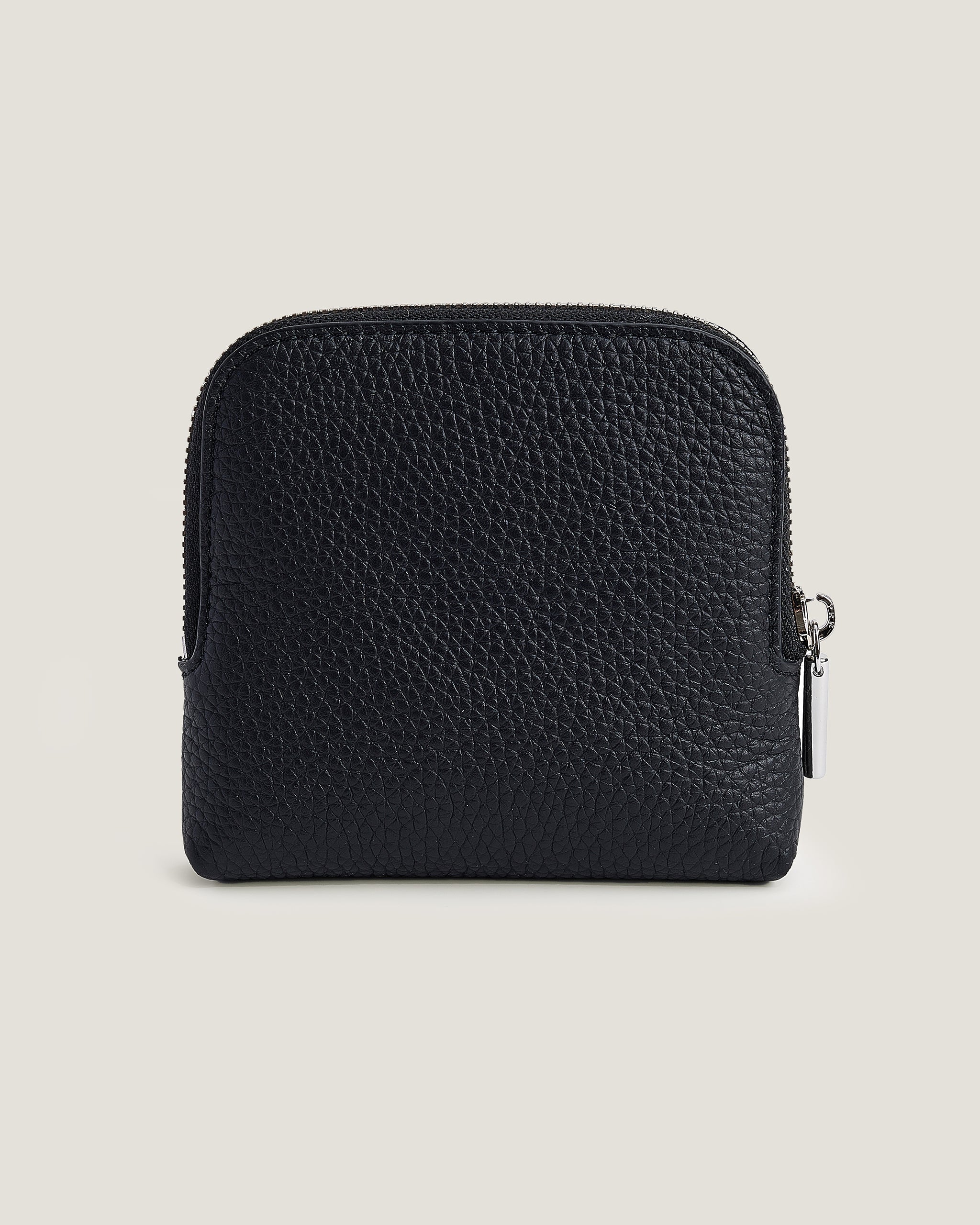 Black leather pouch on a beige background