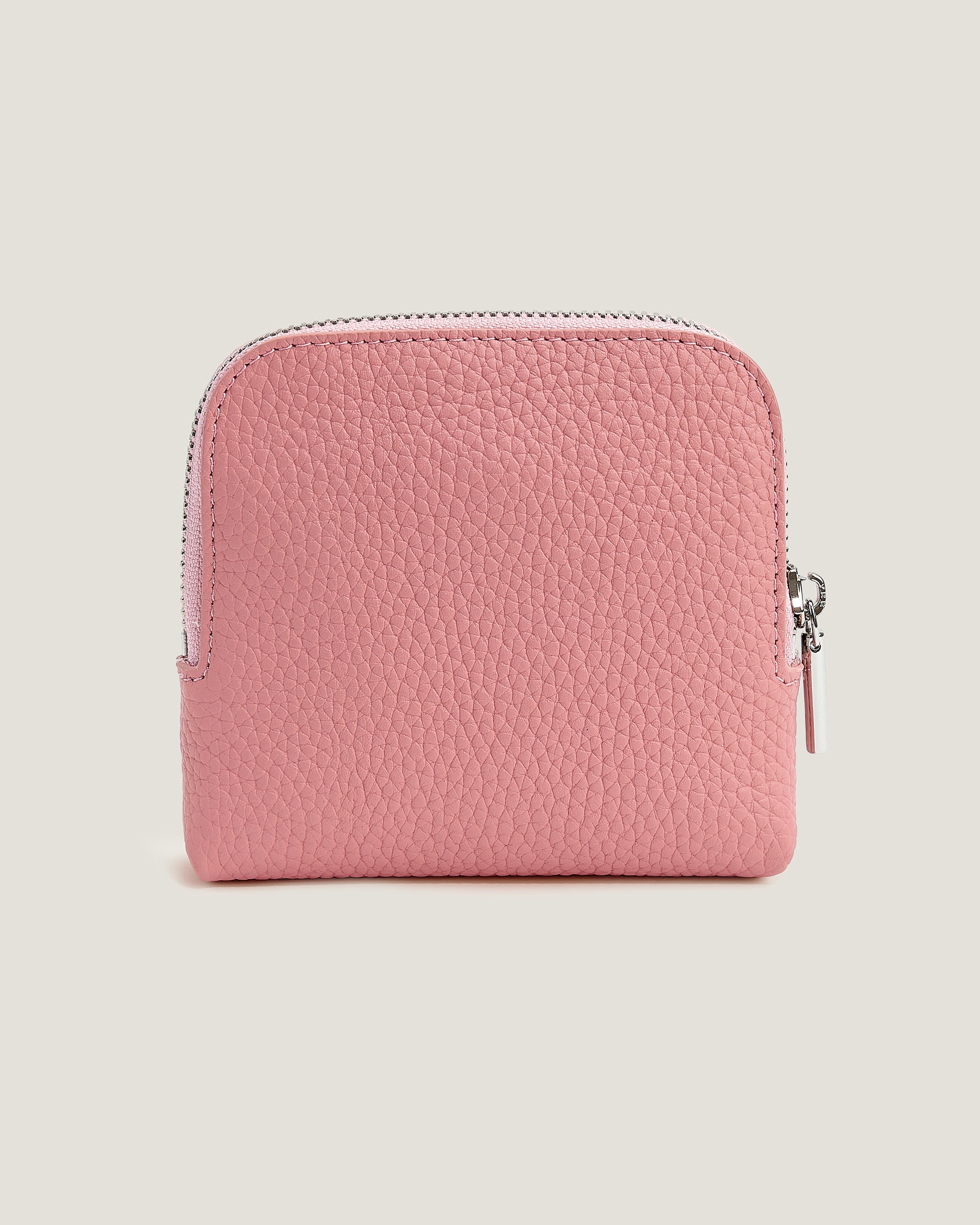 Pink textured wallet on a light beige background