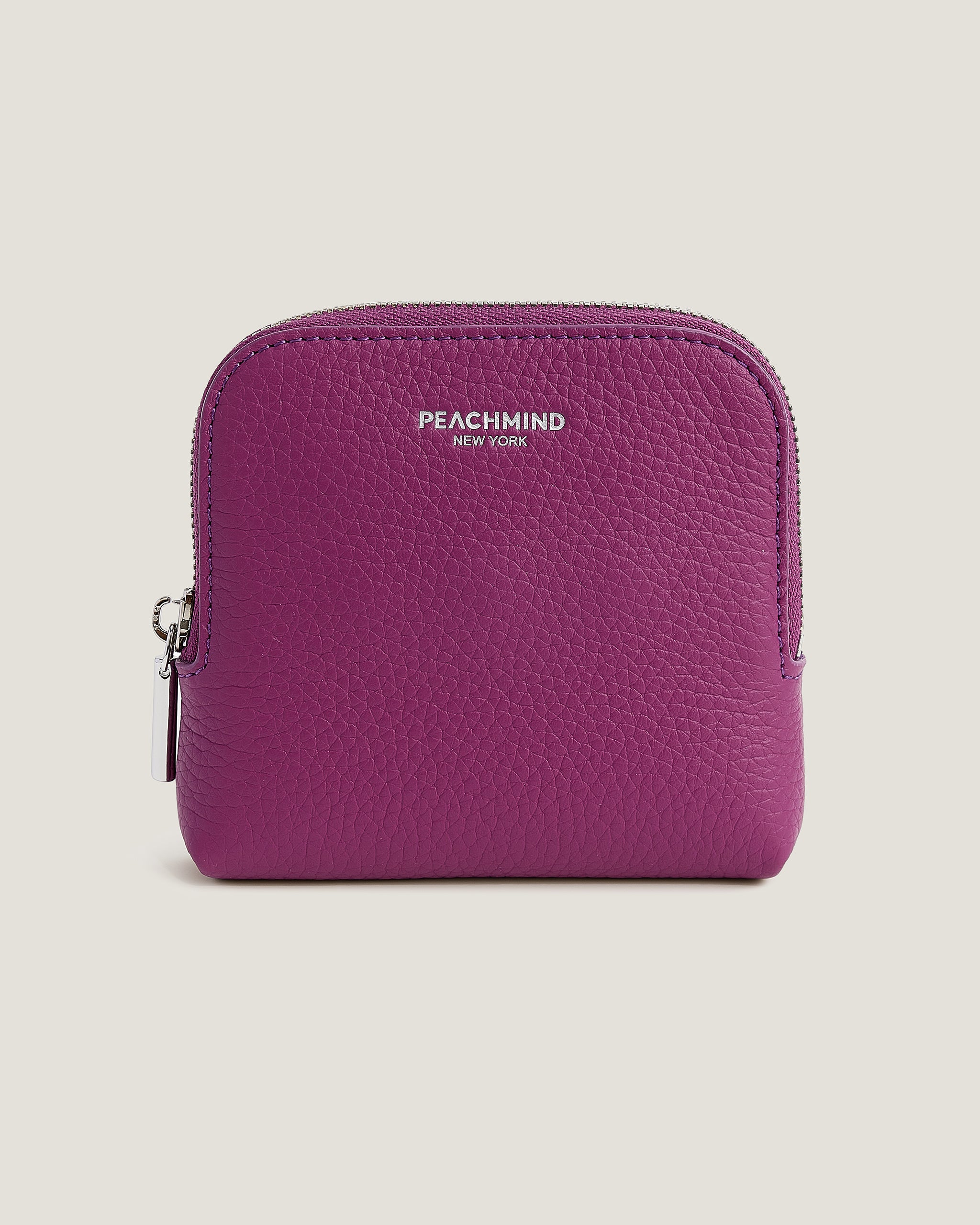 Purple wallet with 'Peachmind' branding on a beige background