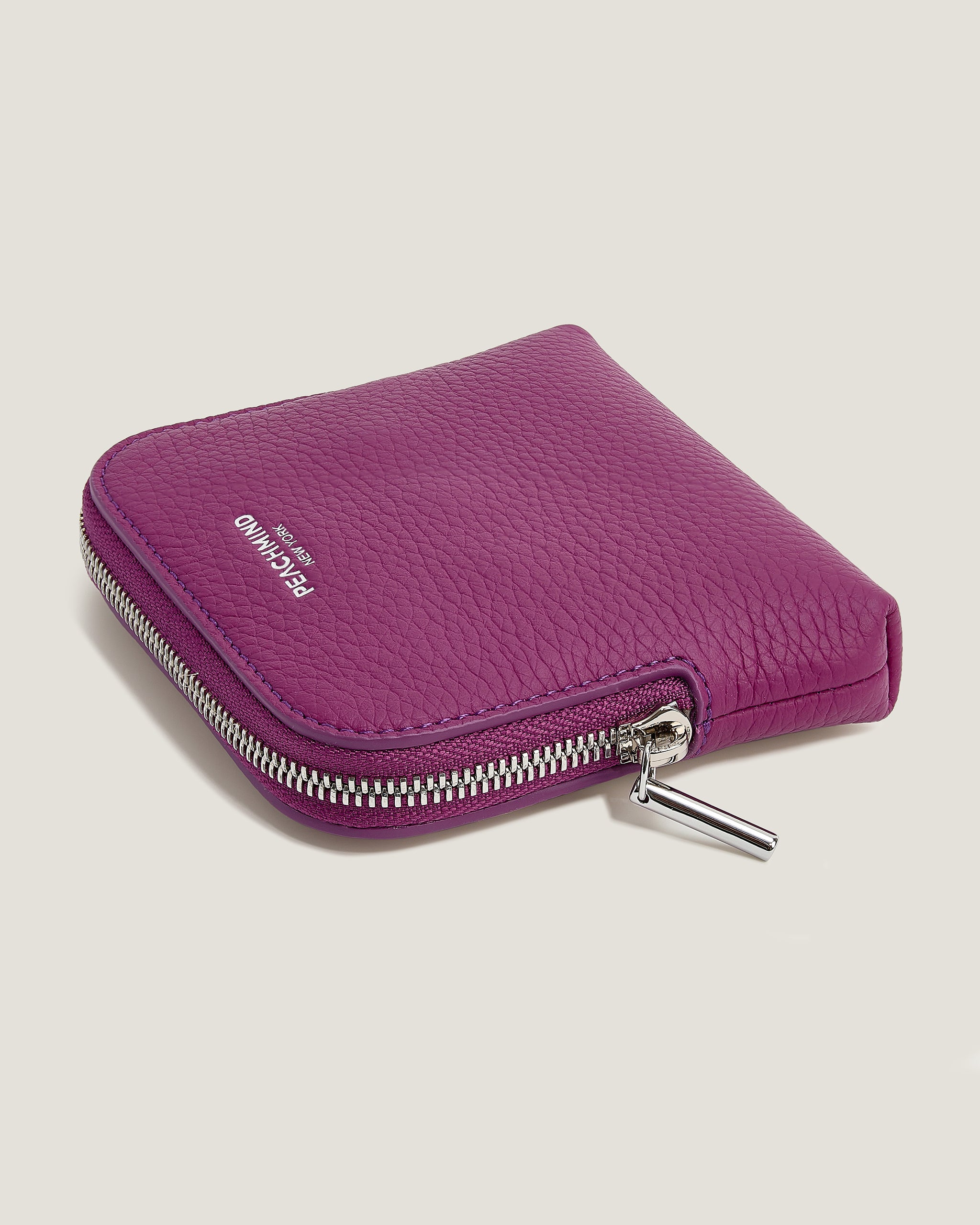 Purple wallet with a brand logo on a light gray background