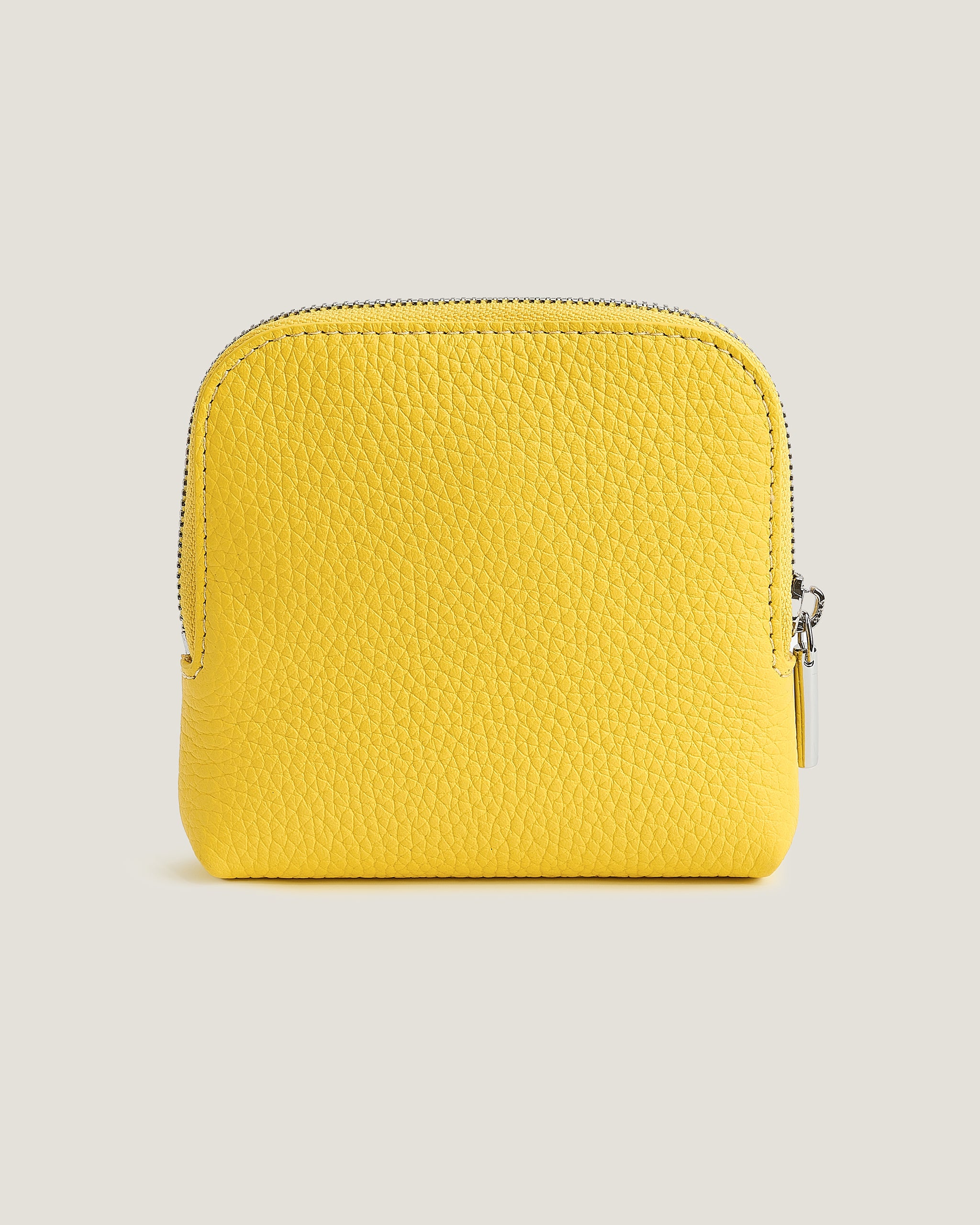 Yellow wallet on a beige background