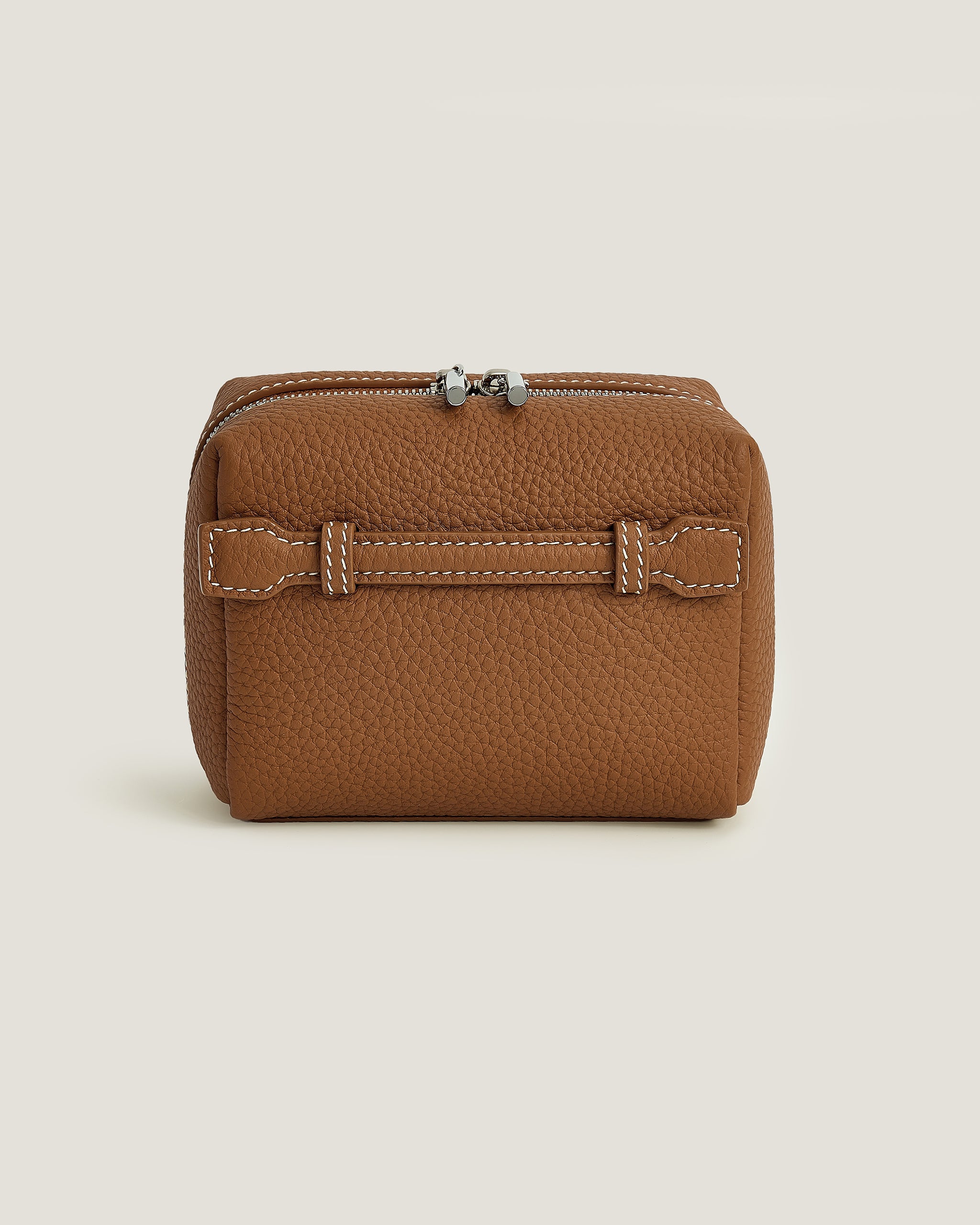 Brown leather makeup pouch on a beige background