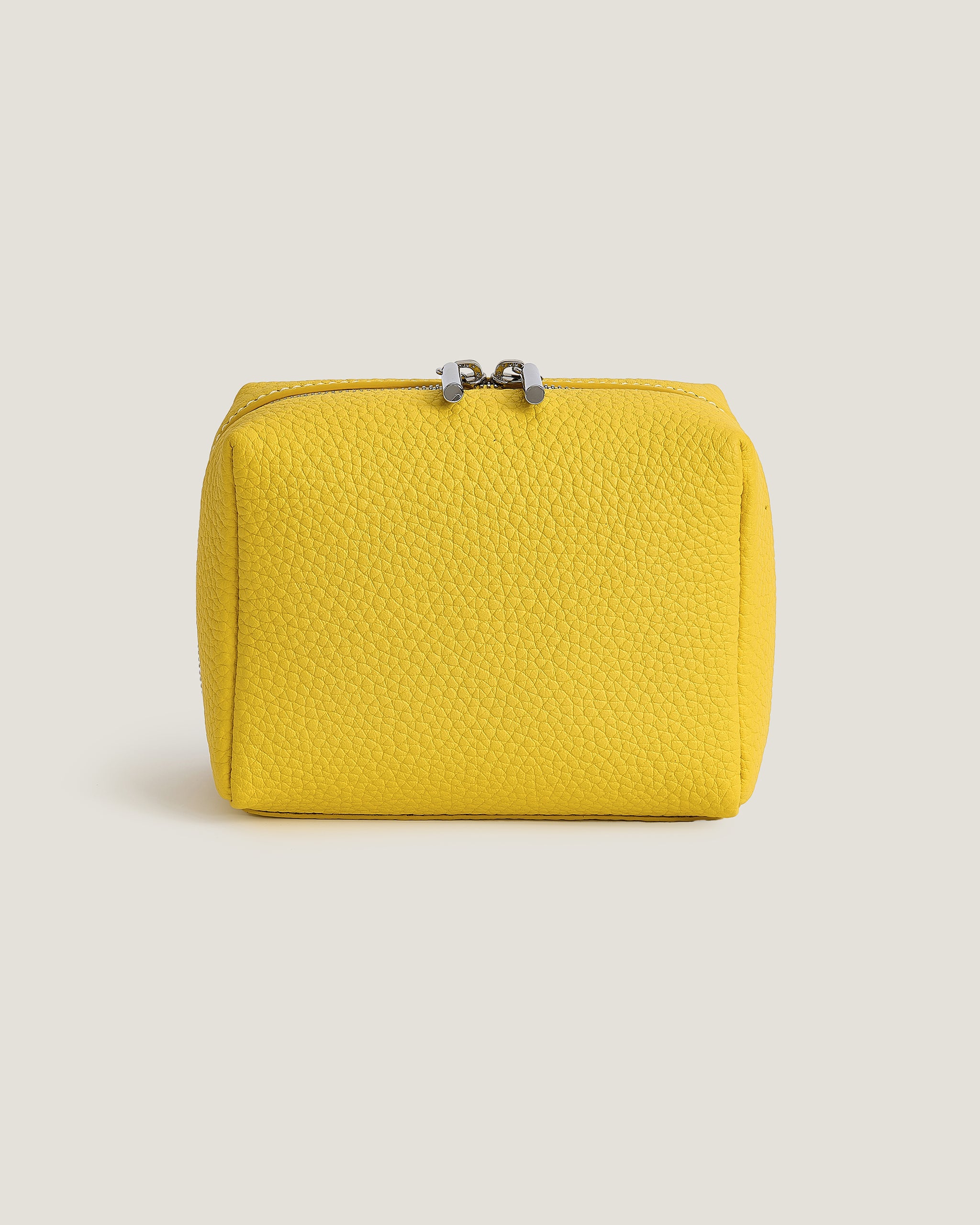 Yellow Leather mini pouch with a zipper on a beige background