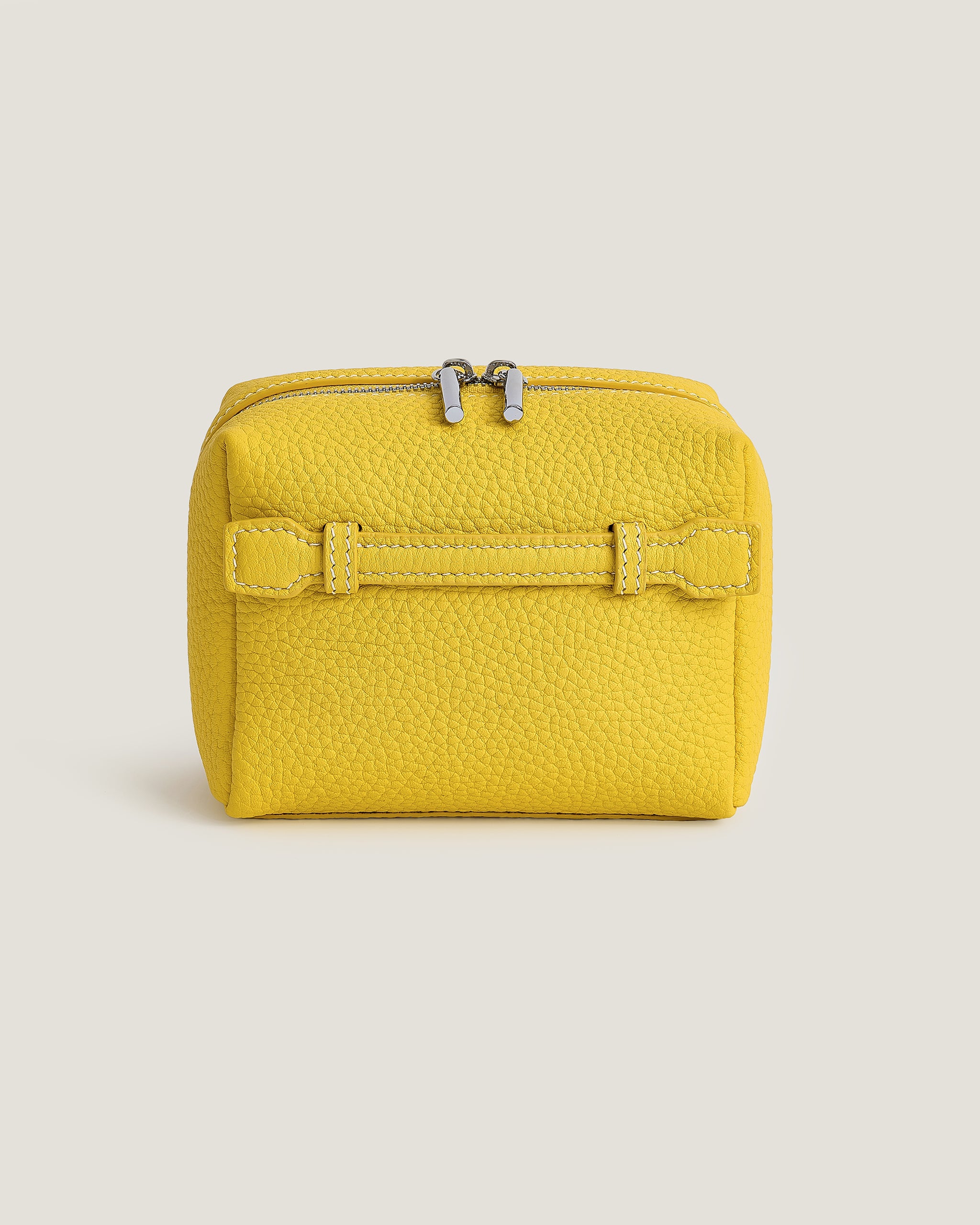 Yellow makeup pouch with a buckle on a light beige background