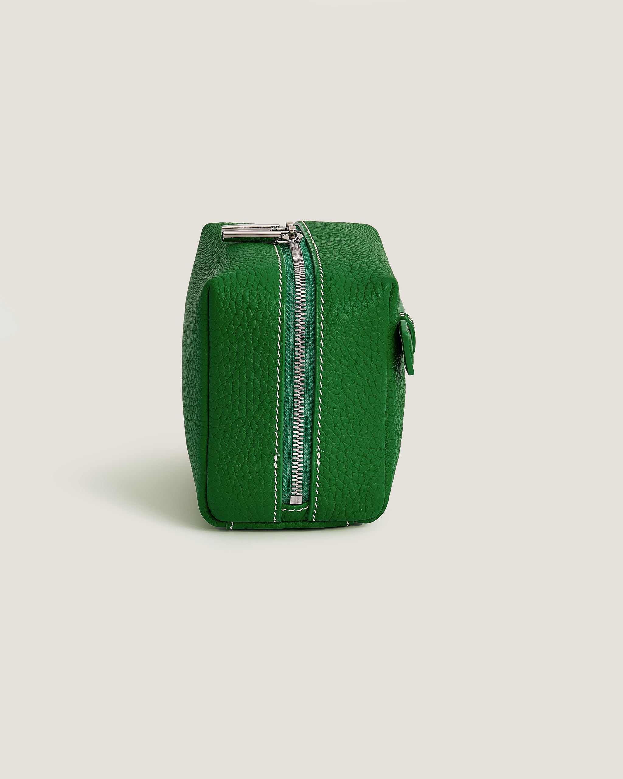 Green rectangular pouch with a zipper on a light gray background