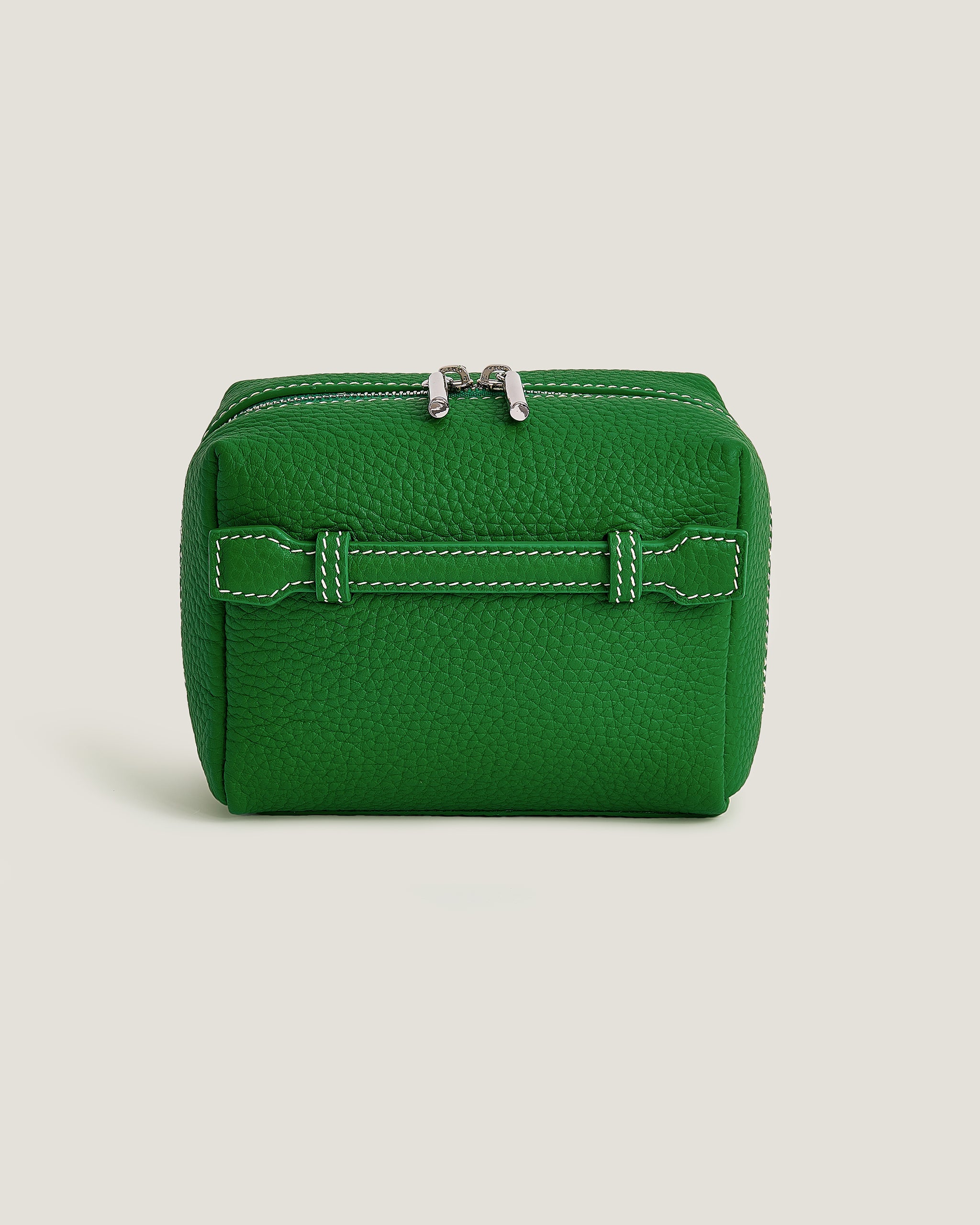 Green leather wallet on a beige background