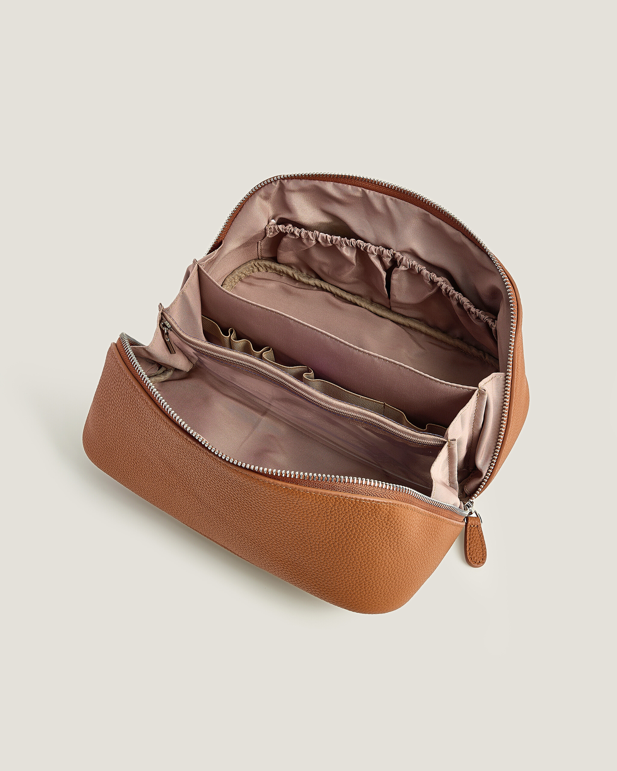 Premium Brown Leather Makeup Bag  for Women with open zipper on a beige background