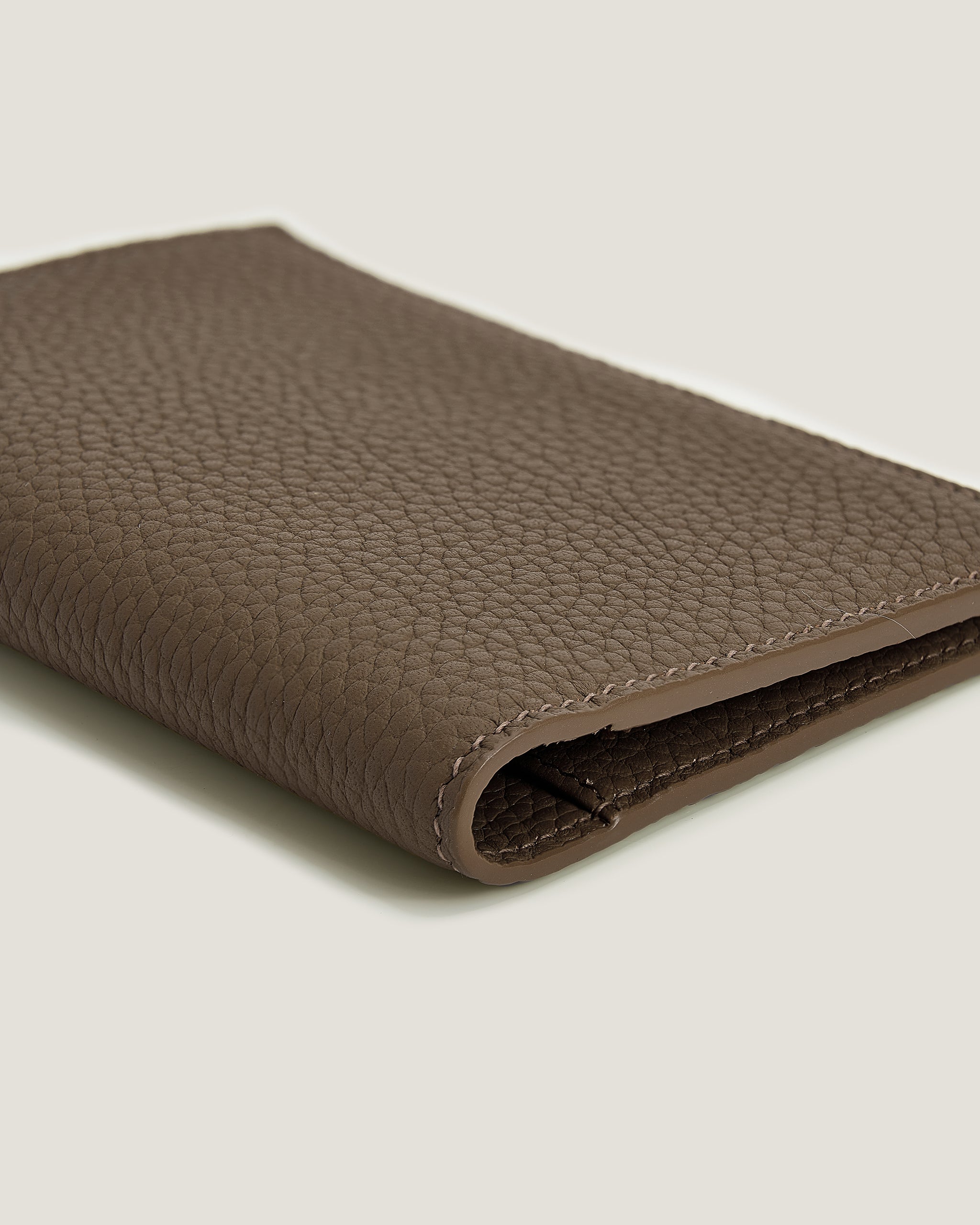 Brown Passport Cover on a light gray background