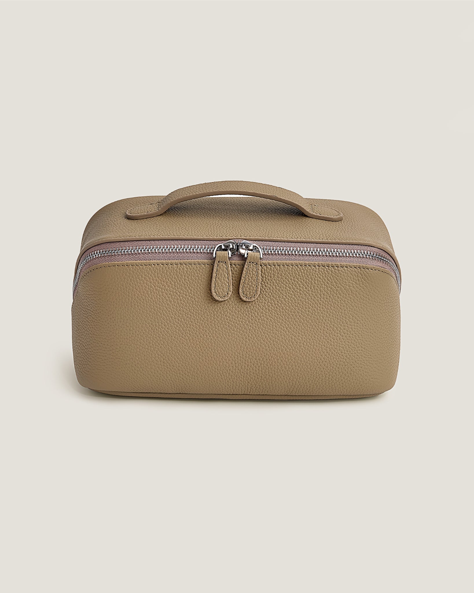 Beige makeup bag with a zipper on a beige background