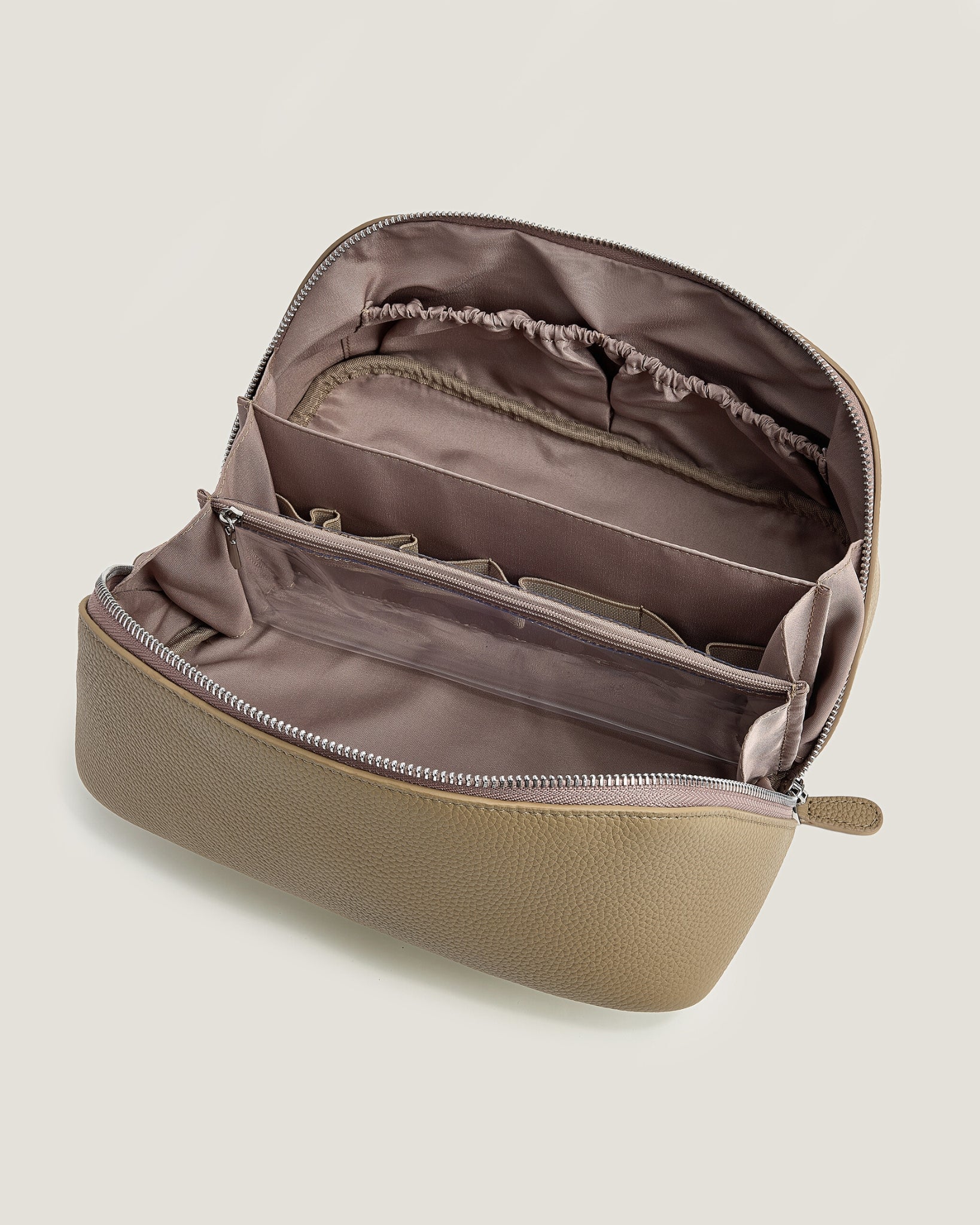 Beige makeup bag with a zipper on a beige background