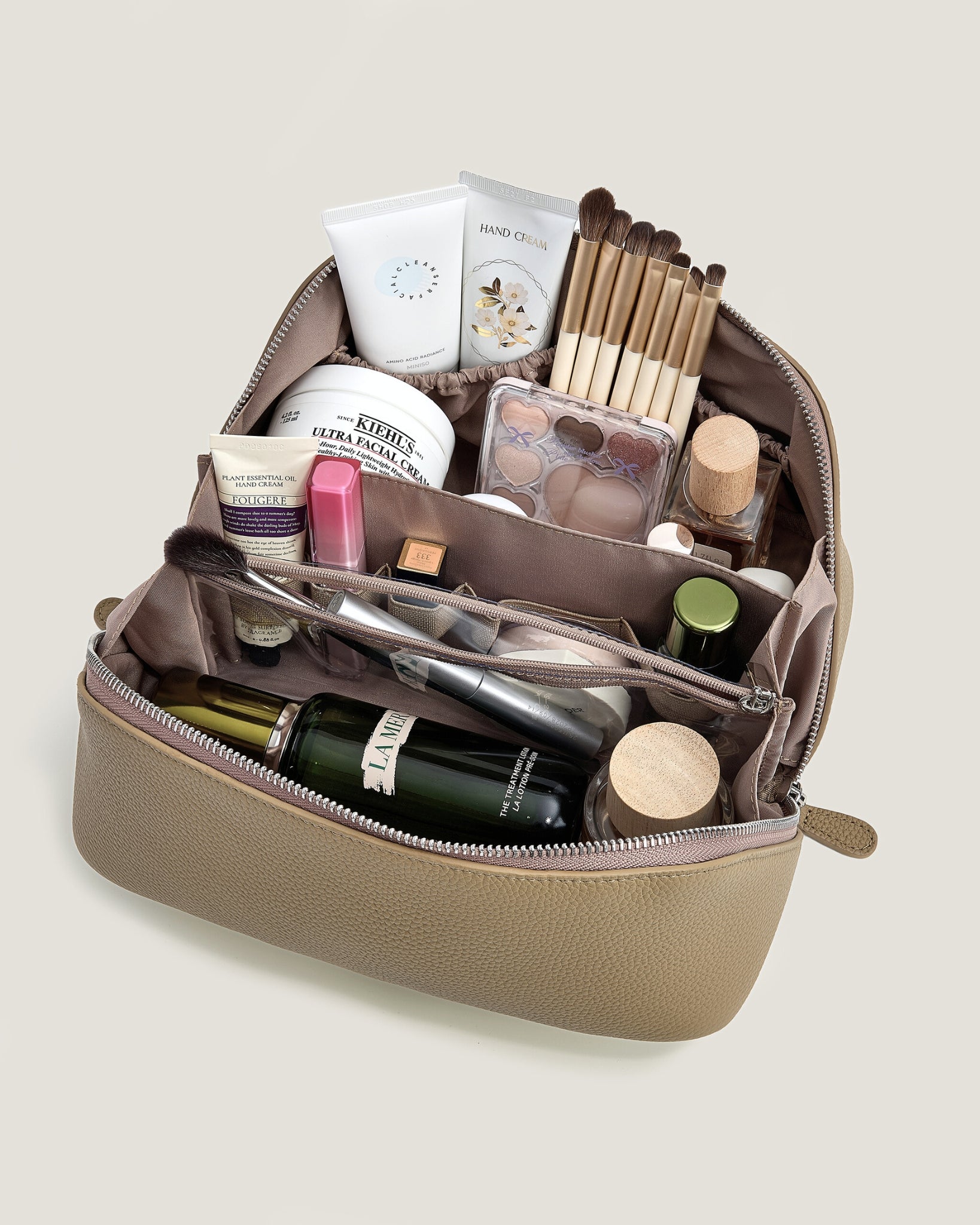 Beige makeup bag with a zipper on a beige background