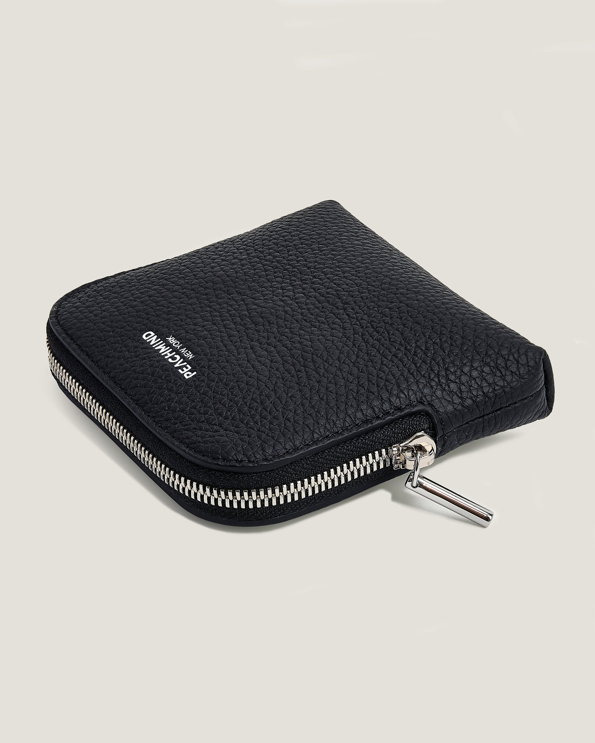 Black zippered pouch on a light gray background
