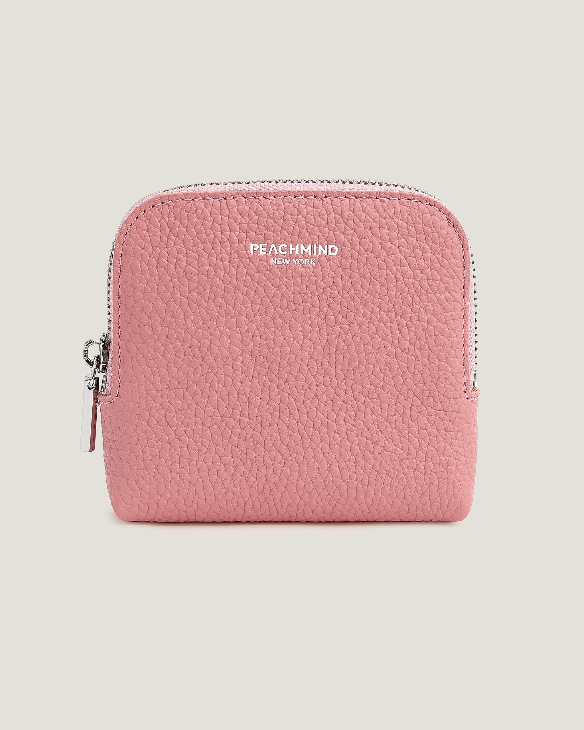Pink wallet with 'Peachmind' branding on a beige background