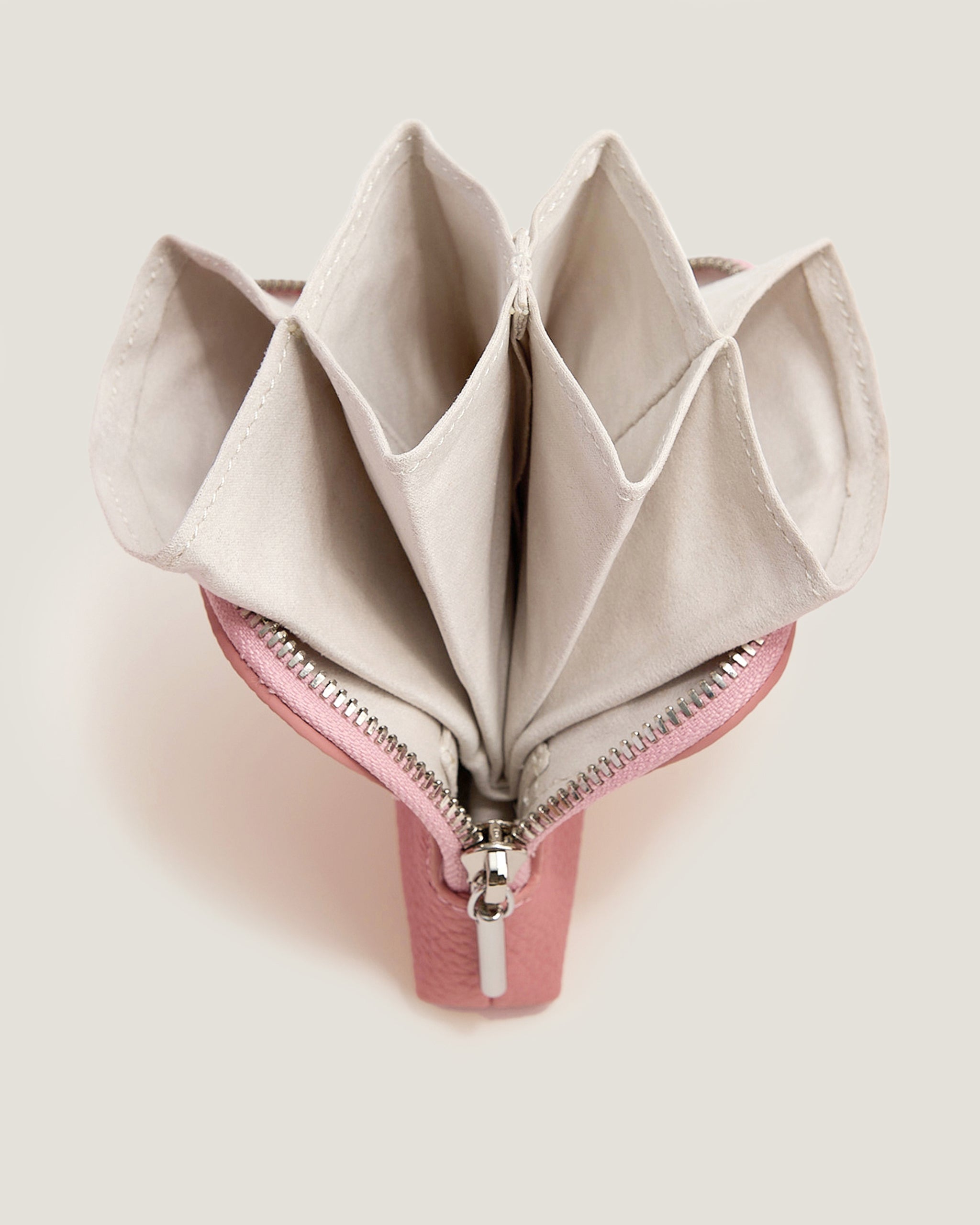 Pink and beige floral-shaped pouch on a light background