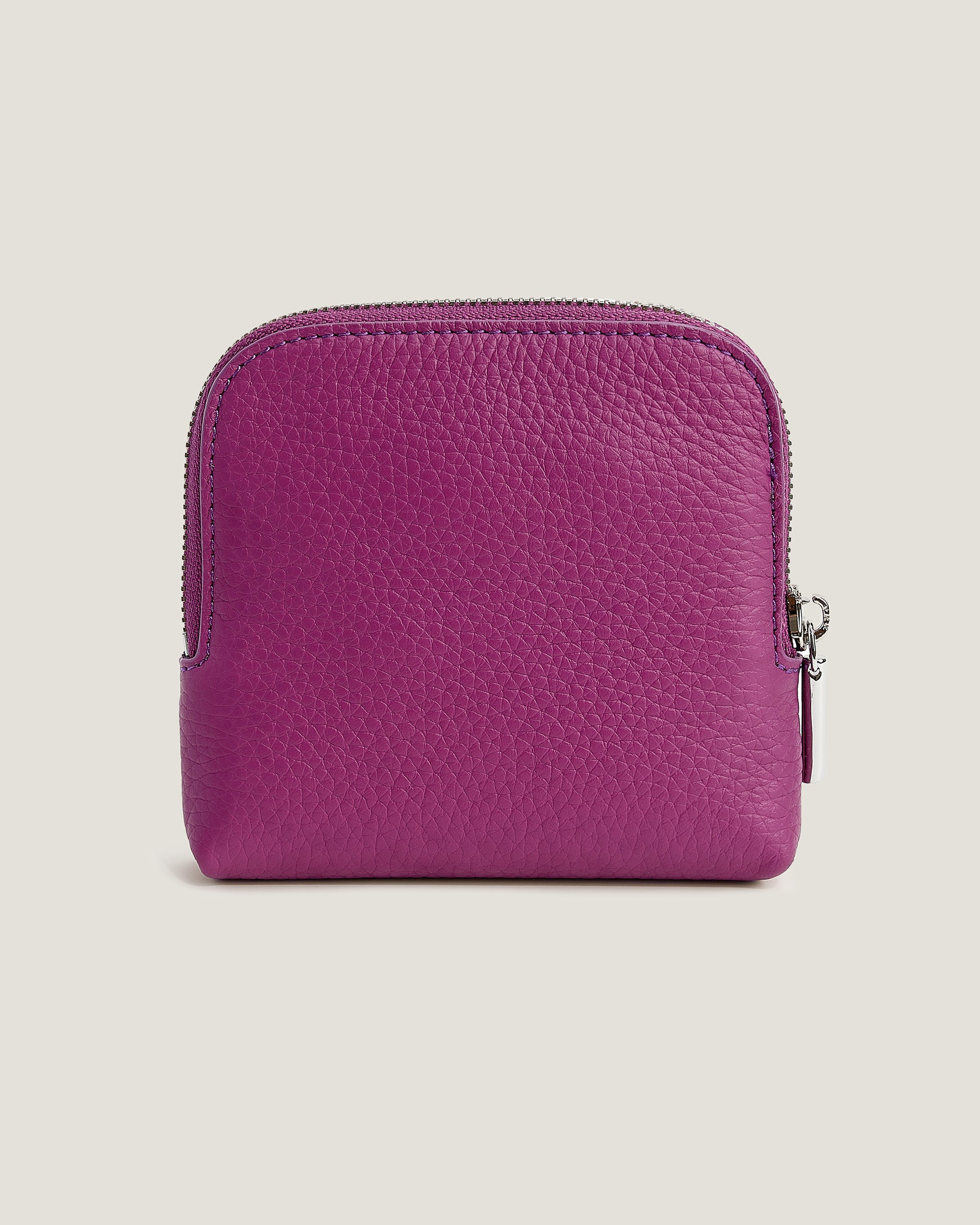 Purple leather wallet on a beige background