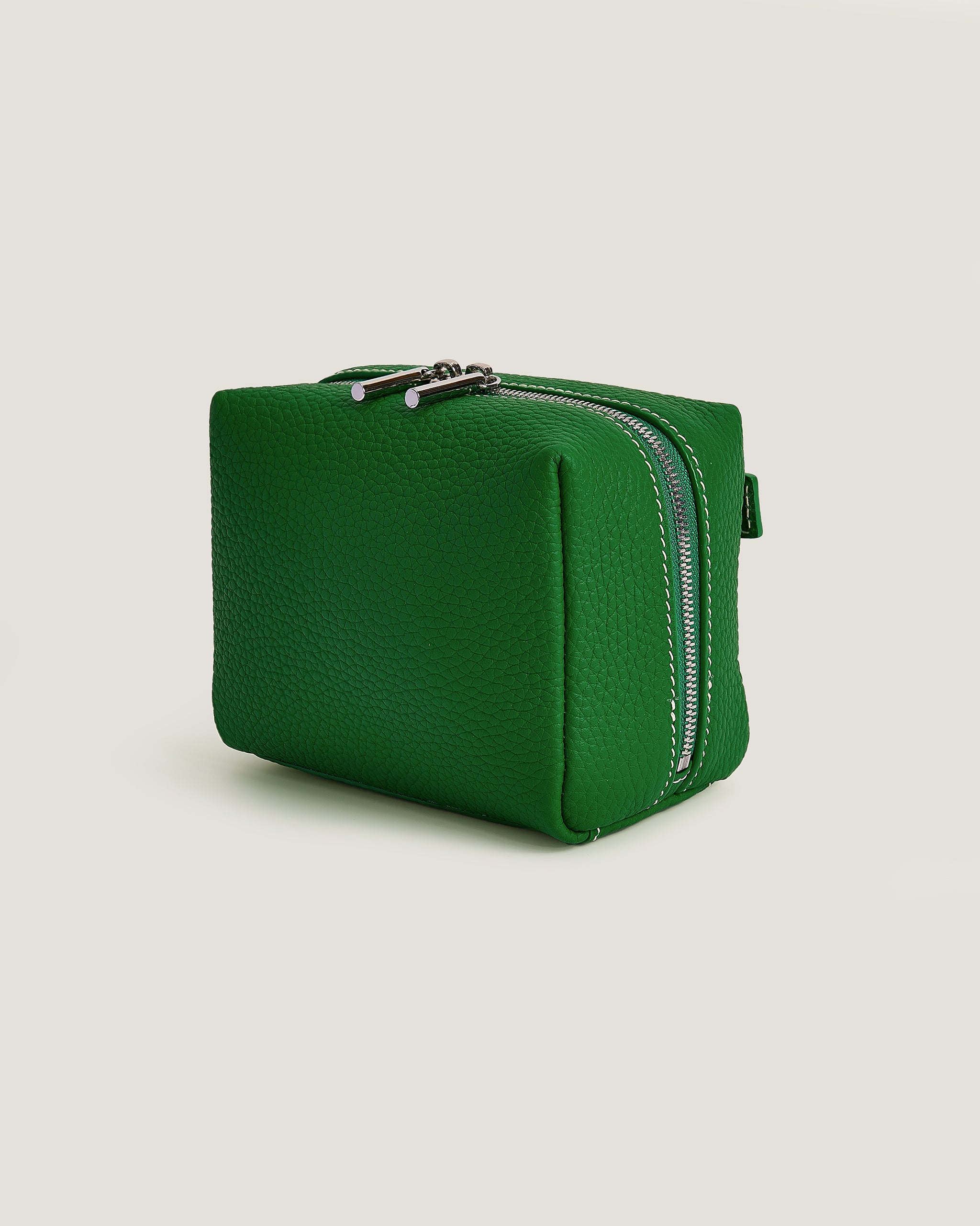Green rectangular pouch with zippers on a light gray background
