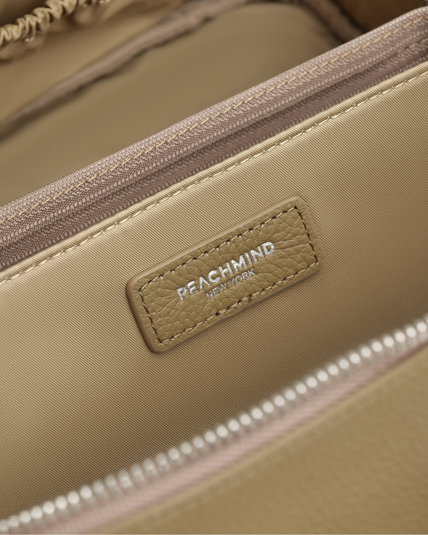 Beige bag with Peachmind New York logo on a beige background